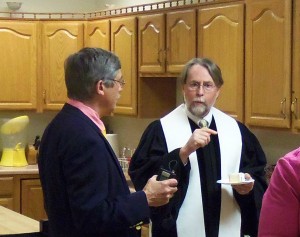 Pastor Phillip and Don Kirk talk in the kitchen.