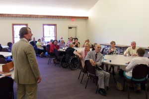 Pastor Phillip speaks to those gathered in the Fellowship Hall.