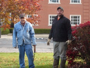 John and Robert trim some shrubs.