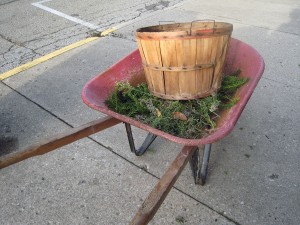 Red wheelbarrow with basket and clippings